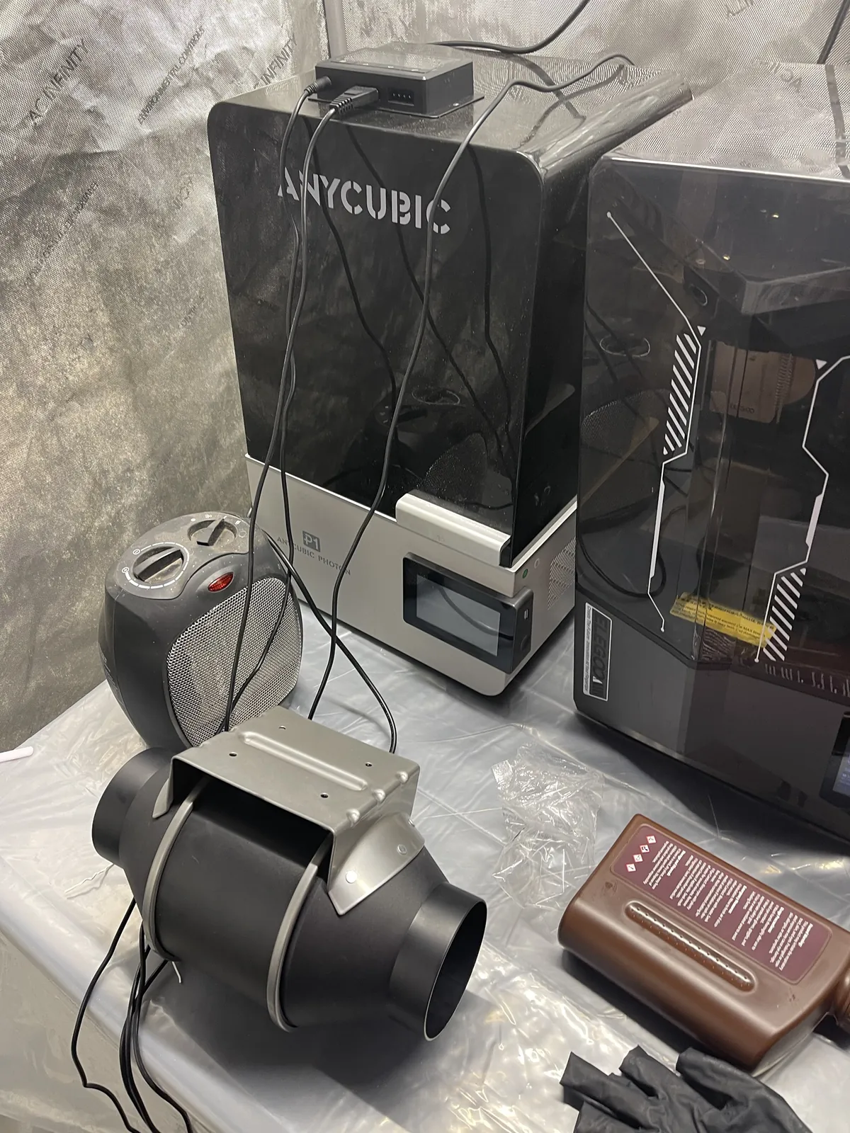 The CLOUDLINE T4 sitting on the plastic-covered table in the tent, not yet connected to any ductwork, with the Photon P1 and the Saturn behind it and a small space heater beside it.